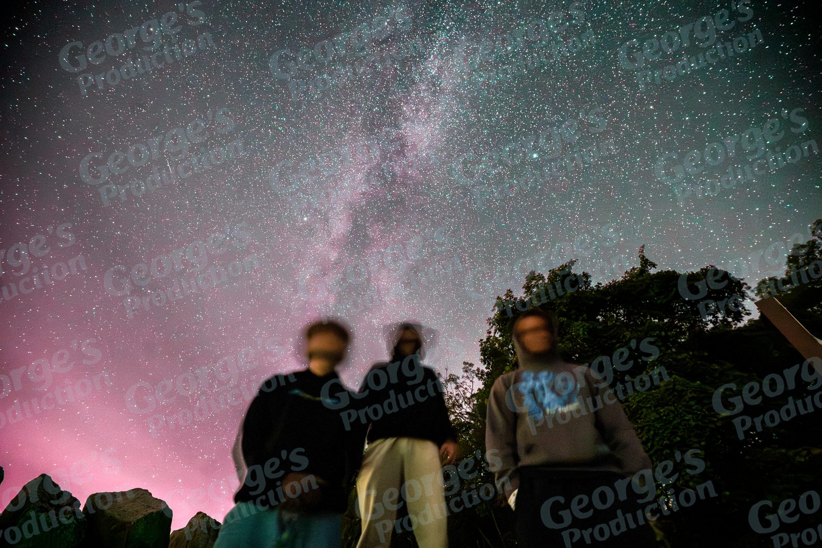 Friends standing under the Milky Way at night